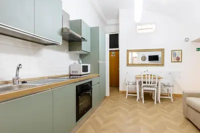 a kitchen with a sink and a table in a room at Colosseum Boutique apartment in Rome