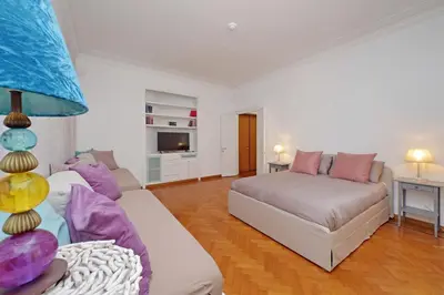 a living room with a couch and a bed at Charme e Style: Splendid Apartment with 2 Bedrooms in Rome