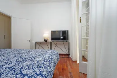 a bedroom with a bed and a flat screen tv at Charme e Style: Splendid Apartment with 2 Bedrooms in Rome