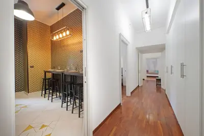 a hallway with a bar and a dining room at Charme e Style: Splendid Apartment with 2 Bedrooms in Rome