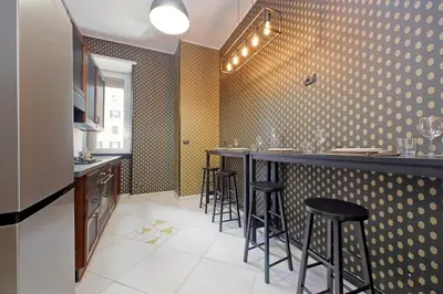 a bar in a restaurant with black stools at Charme e Style: Splendid Apartment with 2 Bedrooms in Rome