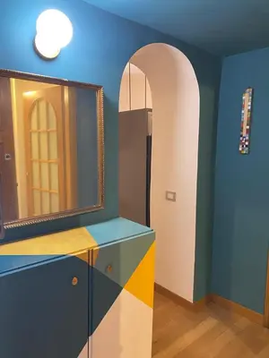 a bathroom with a mirror and a blue wall at Fanfulla Bilocale Pigneto in Rome