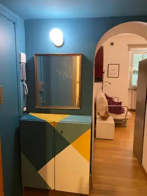 a room with a colorful wall with a mirror at Fanfulla Bilocale Pigneto in Rome