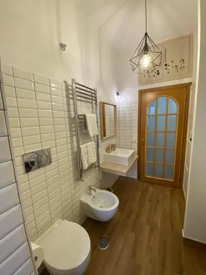 a white bathroom with a toilet and a sink at Fanfulla Bilocale Pigneto in Rome