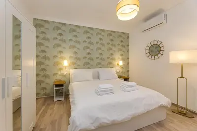 a bedroom with a white bed with towels on it at Cozy Apartment Monteverde near Trastevere in Rome