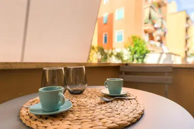 a table with two cups and two wine glasses at Cozy Apartment Monteverde near Trastevere in Rome