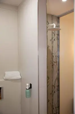 a shower in a bathroom with a glass door at Casa Cipradino in Rome
