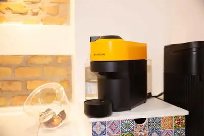 a coffee maker sitting on a shelf next to a coffee pot at Casa Cipradino in Rome