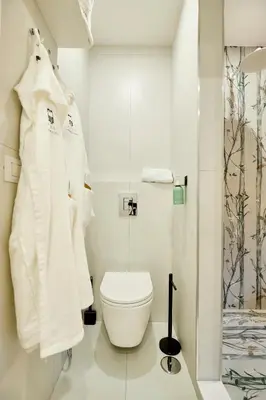 a bathroom with white towels and a toilet at Casa Cipradino in Rome