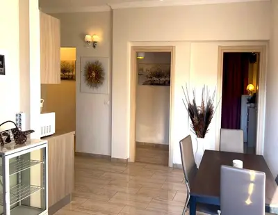 a kitchen and dining room with a table and chairs at Ariana Apartments in Rome