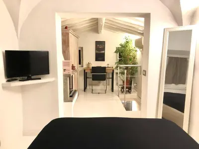 a room with a bed and a television and a table at Navona Luxury Suite Apartment by NDP rent in Rome