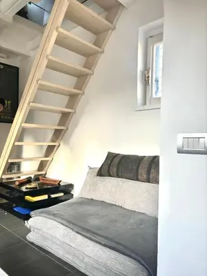 a bedroom with a ladder and a bed in it at Navona Luxury Suite Apartment by NDP rent in Rome