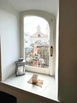 an open window with a view of a city at Navona Luxury Suite Apartment by NDP rent in Rome