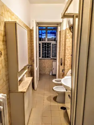 a bathroom with two sinks and a toilet and a window at Loryand near Stadio Olimpico in Rome