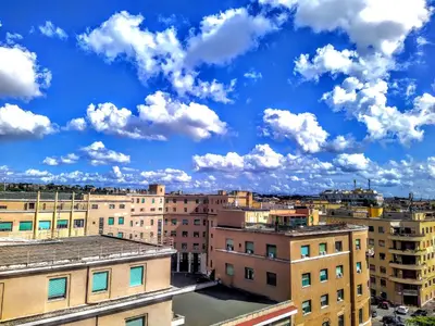 a city skyline with buildings and a cloudy sky at Loryand near Stadio Olimpico in Rome