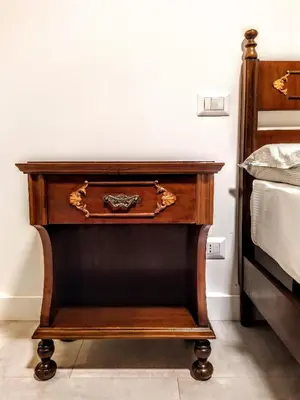 a wooden nightstand with a drawer next to a bed at Loryand near Stadio Olimpico in Rome