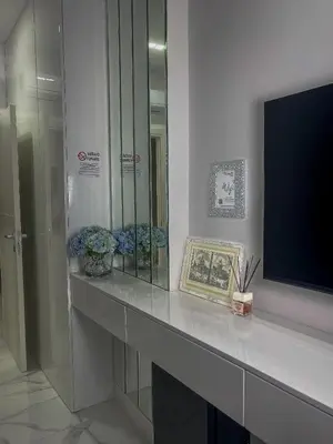 a desk with a television and flowers on it at Alissa Suite in Rome