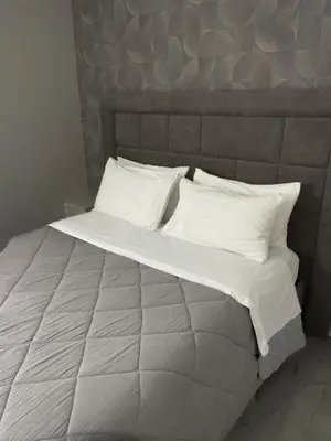 a large bed with white sheets and pillows at Alissa Suite in Rome