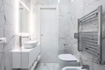 a white bathroom with a toilet and a sink at Alissa Suite in Rome