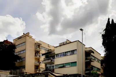 an apartment building with a cloudy sky in the background at Vatican View in Rome