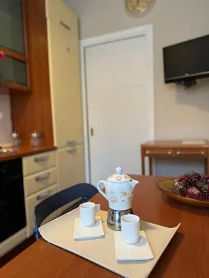a table with two cups and a tea pot on it at Dora Apartment in Rome