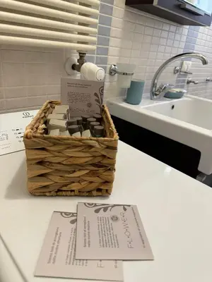 a basket of soap sitting on a counter next to a sink at Dora Apartment in Rome