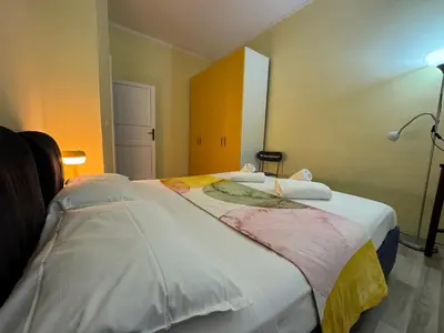 a bedroom with a large bed with white sheets at Dora Apartment in Rome