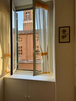 a window with a view of a building at Dora Apartment in Rome