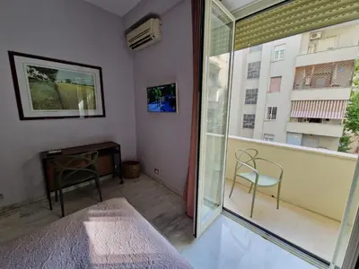 a bedroom with a balcony with a bed and a window at Incantevole appartamento nel Parco dell'Aniene! in Rome