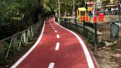 a red road with a toy ride in a park at Incantevole appartamento nel Parco dell'Aniene! in Rome