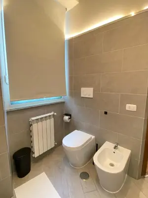 a bathroom with a white toilet and a sink at Residenza AURELIA in Rome