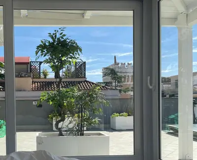 a sliding glass door with a view of a balcony at Caesars penthouse in Rome