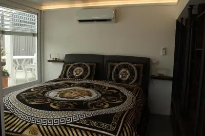 a bedroom with a bedspread with a picture on it at Caesars penthouse in Rome