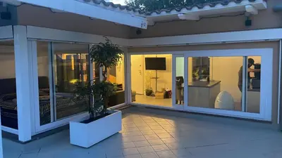 a room with sliding glass doors with plants on it at Caesars penthouse in Rome