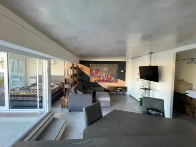 a living room with a couch and a bed at Caesars penthouse in Rome
