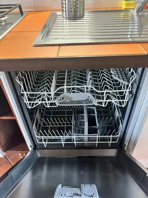 a drawer in a dishwasher filled with dishes at Trastevere al Leopardo in Rome