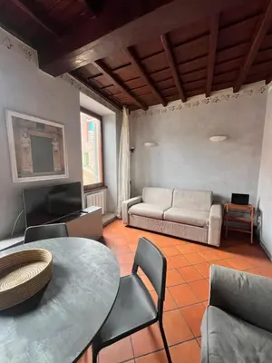 a living room with a table and a couch at Trastevere al Leopardo in Rome