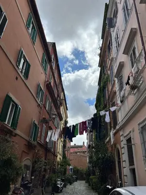 a narrow alley with clothes hanging on a clothes line at Trastevere al Leopardo in Rome