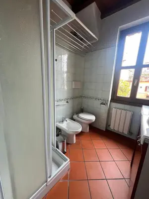 a bathroom with two toilets and a sink and a shower at Trastevere al Leopardo in Rome