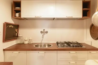 a kitchen with a sink and a stove at Piazza Navona Historic Luxury Apartment in Rome