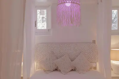 a bedroom with a bed with a pink chandelier at Piazza Navona Historic Luxury Apartment in Rome
