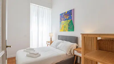 a bedroom with a bed with towels on it at Domus San Giovanni Elegant Apartment in Rome
