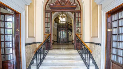 a hallway with a staircase in a building at Domus San Giovanni Elegant Apartment in Rome