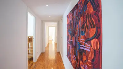a large painting on the wall in a hallway at Domus San Giovanni Elegant Apartment in Rome