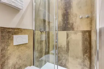 a shower with a glass door in a bathroom at SCIPIONI 40 GUESTHOUSE in Rome