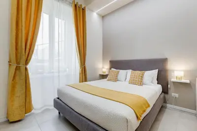 a bedroom with a bed and a large window at SCIPIONI 40 GUESTHOUSE in Rome