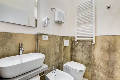 a bathroom with a white sink and a toilet at SCIPIONI 40 GUESTHOUSE in Rome