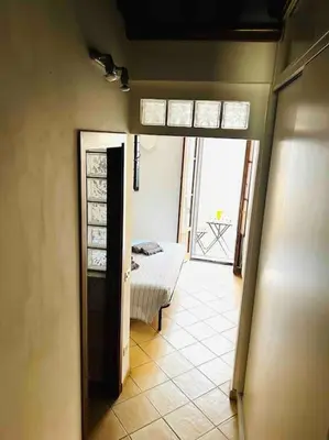 a hallway with a room with a bed and a window at Trastevere Moro apartment in Rome