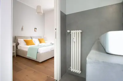 a bedroom with a bed and a radiator at Apartment near the Vatican Cipro metro station in Rome