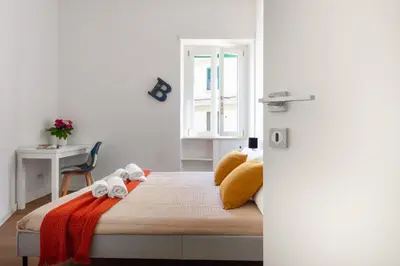 a bedroom with a bed with two stuffed animals on it at Apartment near the Vatican Cipro metro station in Rome